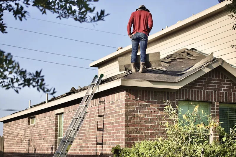 Professional roofer working on a residential roof in North Ridge